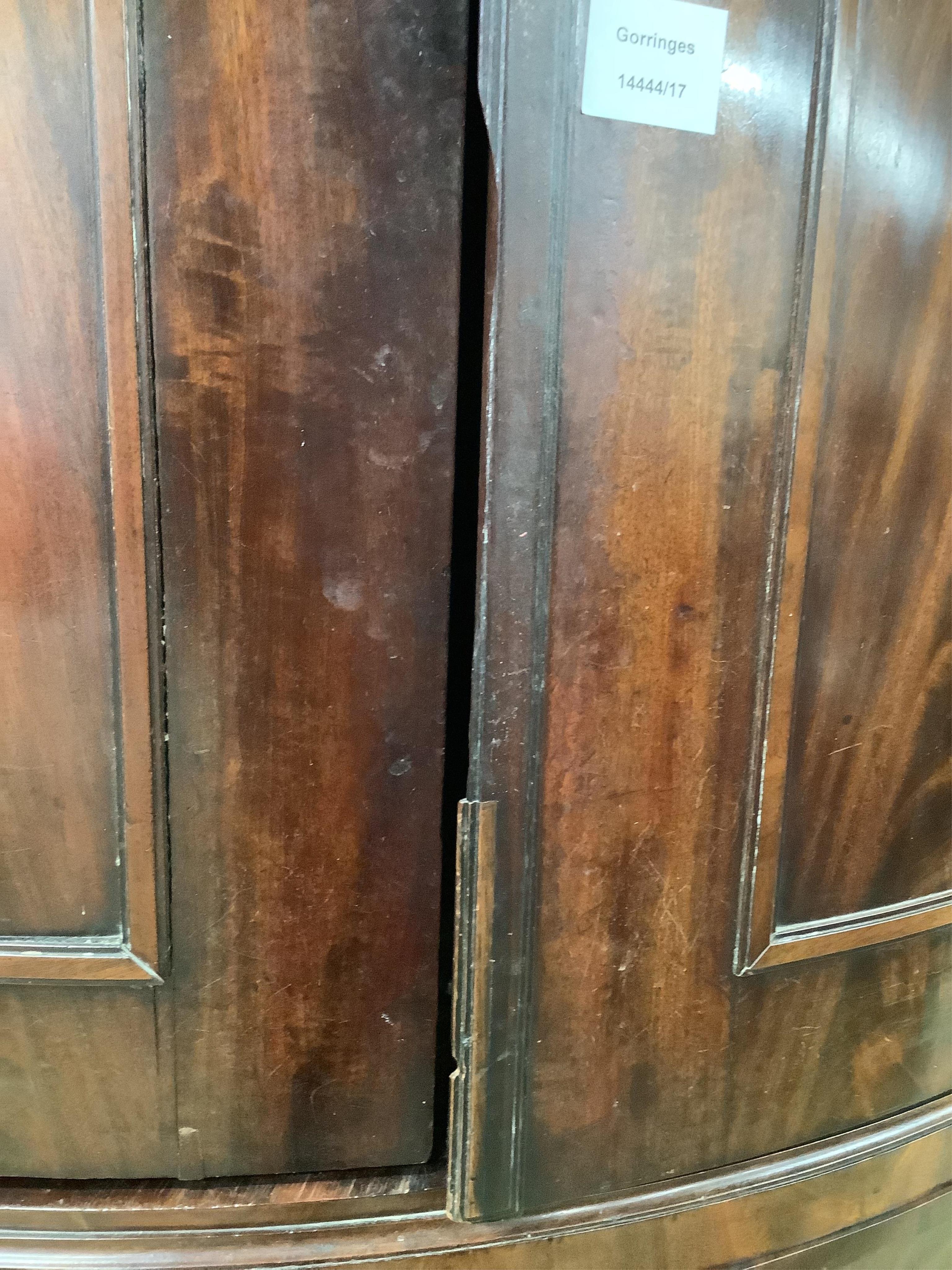 An unusually tall late 18th century Dutch mahogany bow fronted corner cabinet, in two sections, width 130cm, depth 82cm, height 265cm. Condition - fair
